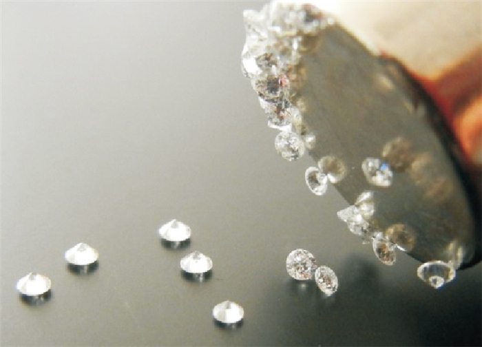 HPHT grown small diamonds being attracted by strong magnet.