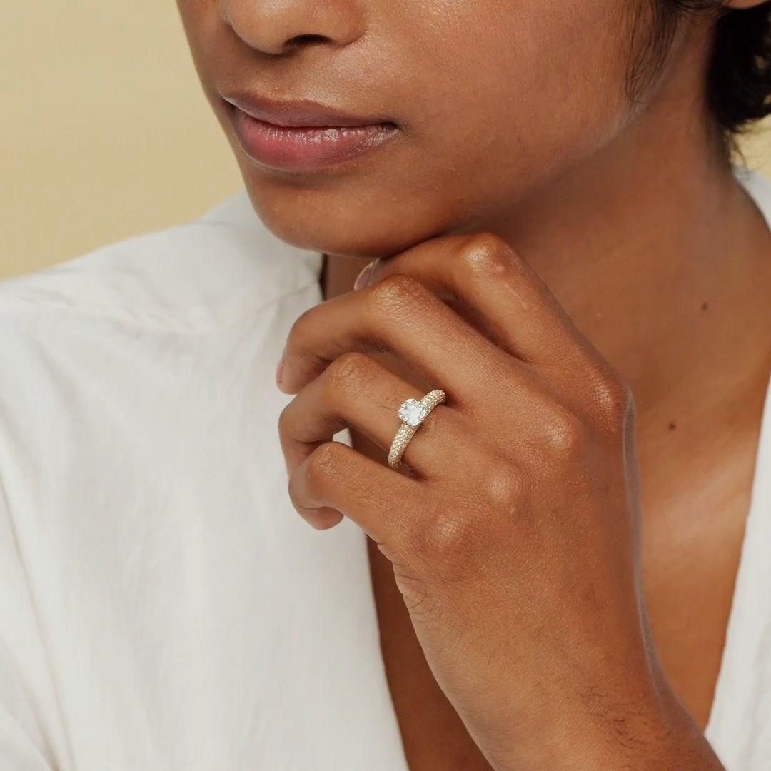 This is the Curator Cushion Engagement Ring in 18k yellow gold with a 1.5ct Cushion lab-grown diamond, pavé band, from Vrai. Displayed on a model's hand.